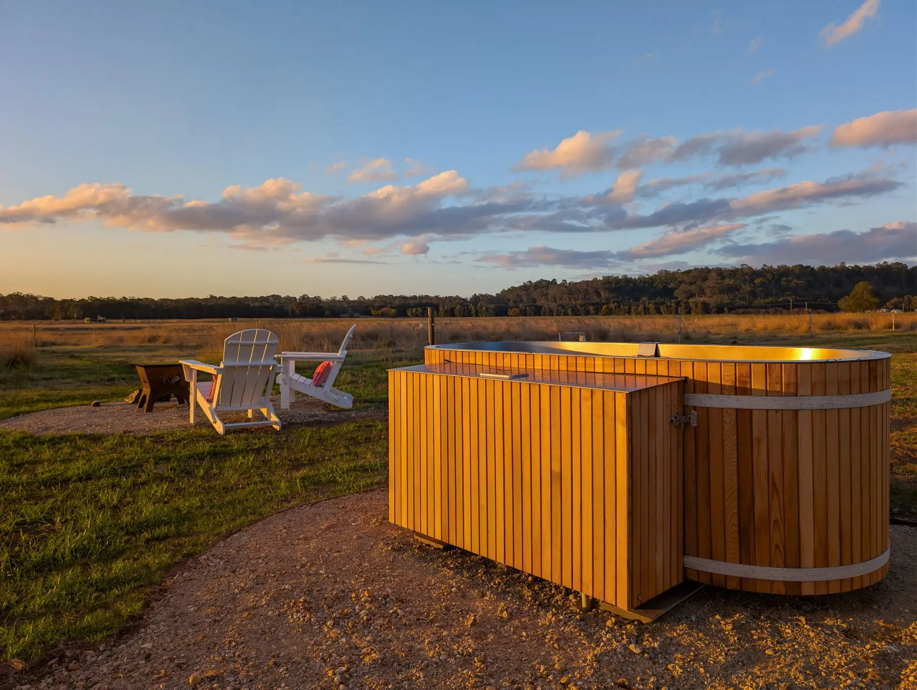 The cedar outdoor bath and firepit at golden hour