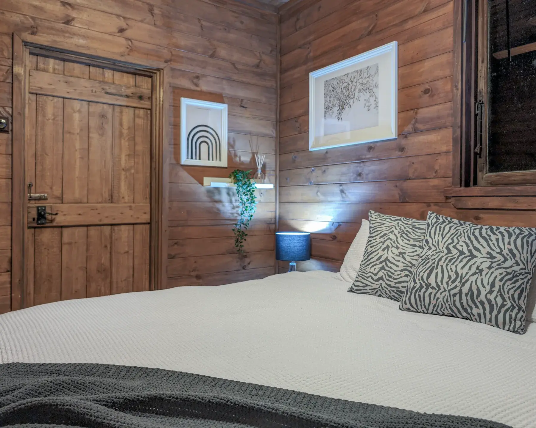 Bedroom two at the Cottage, the second king bed behind a timber door