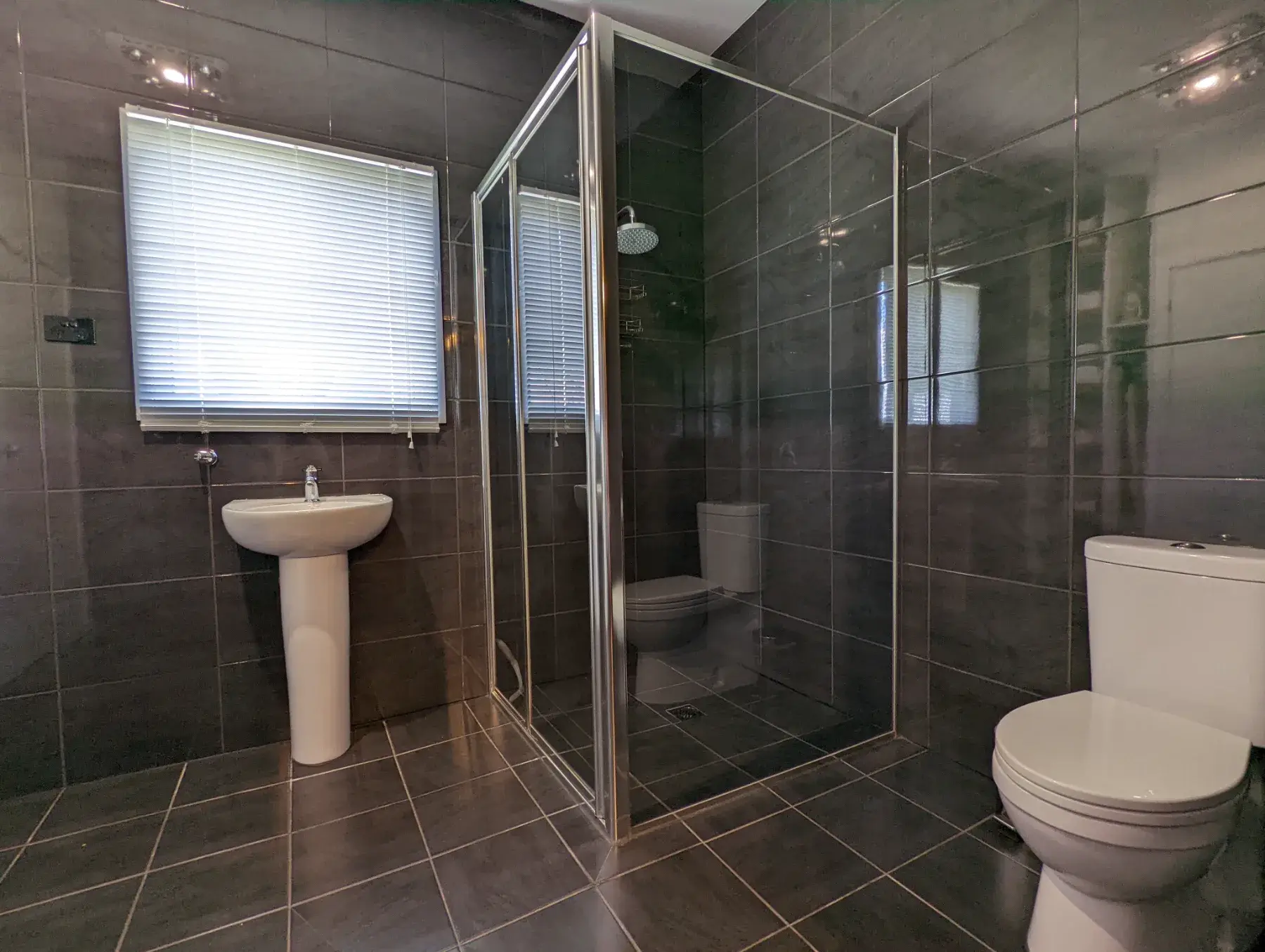 Ensuite one at the Cottage, a walk-in shower tiled floor to ceiling