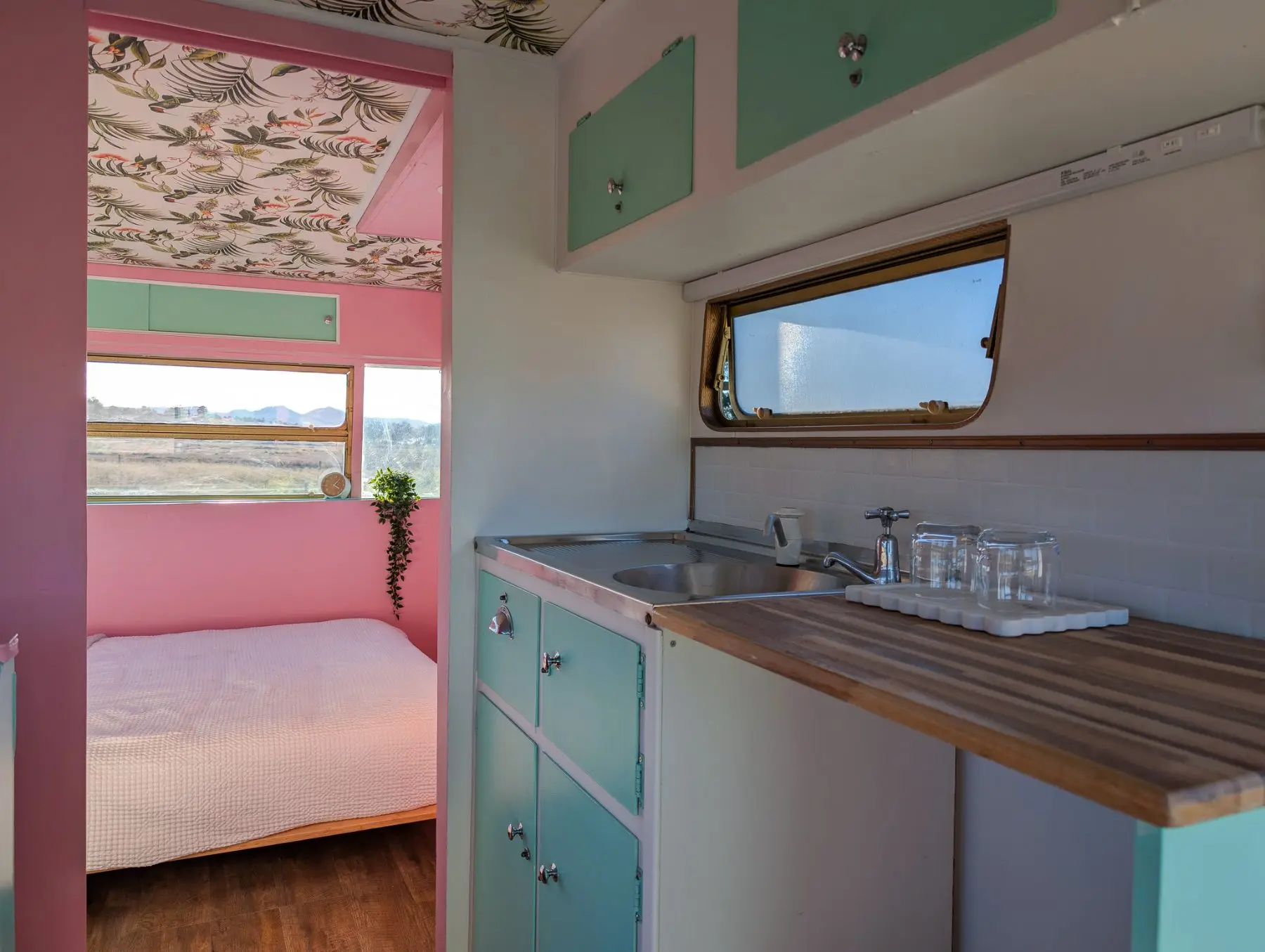 The kitchenette in the van: sink, bench and glasses